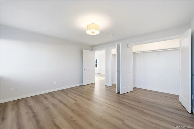 a bathroom with a toilet a sink a glass door a shower a mirror and vanity