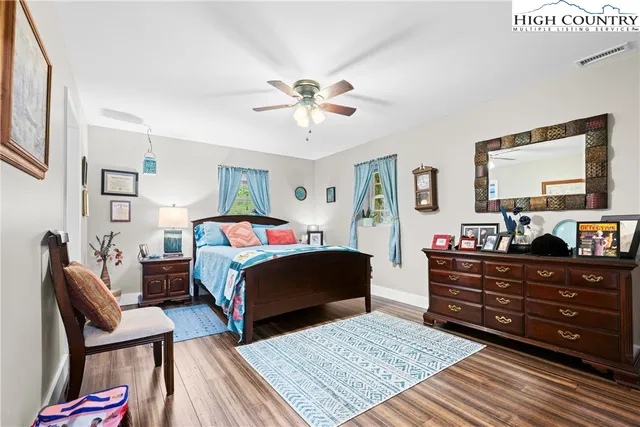 a bed room with a bed and a chair