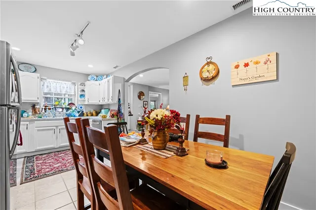 a kitchen with stainless steel appliances granite countertop a stove a sink and white cabinets