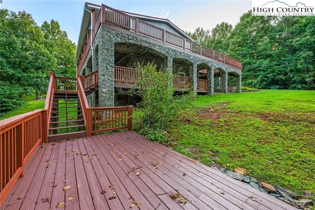 a view of house with wooden floor and fence