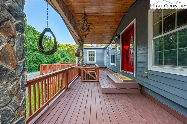 a view of two chairs in balcony with wooden floor
