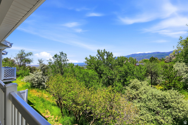 3766 Cardiff Circle Bountiful, UT 84010 - Photo 20 of 46 Balcony with white railing overlooking a verdant landscape, distant mountains, and a body of water