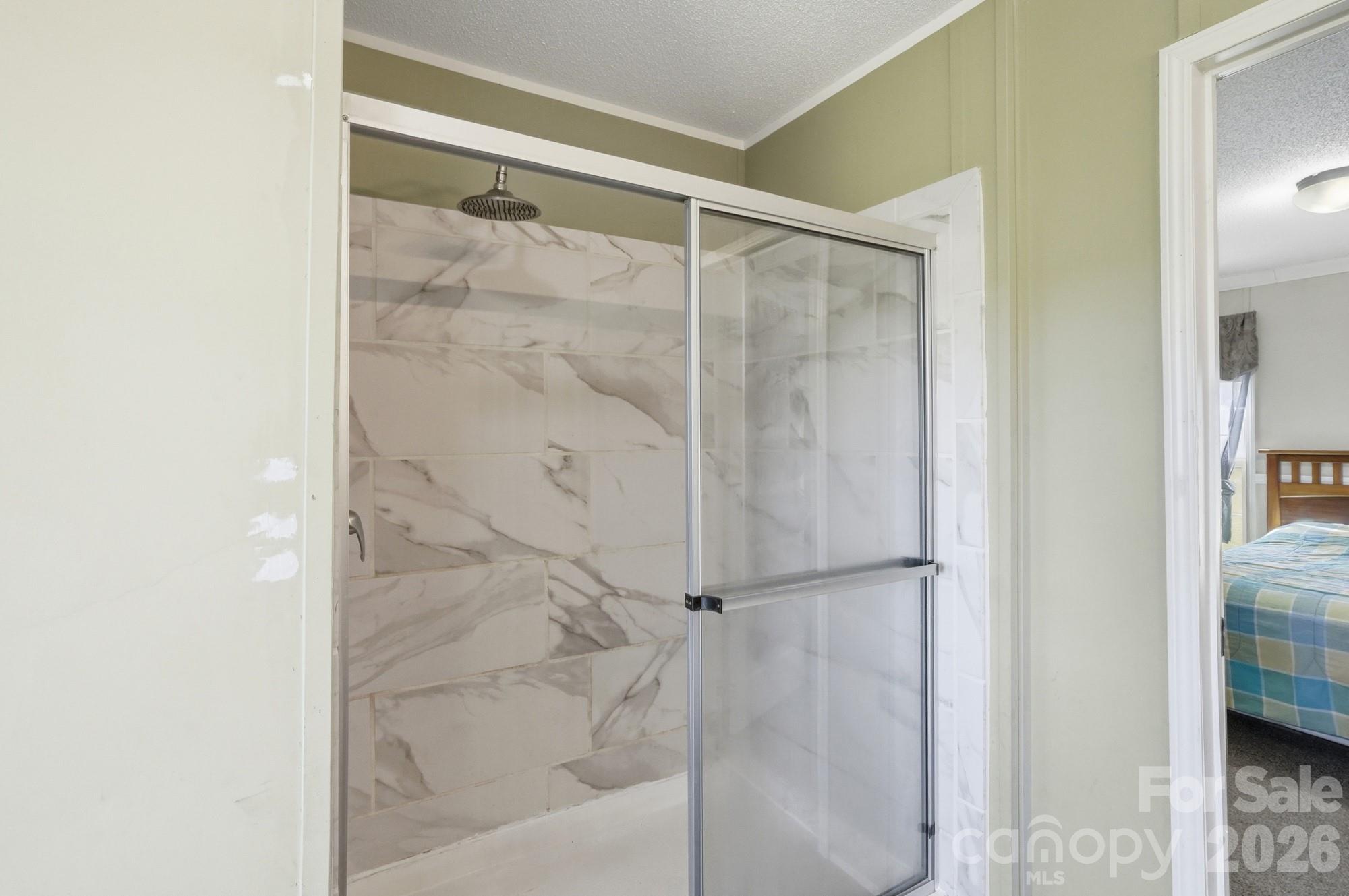 4111 Clontz Taylor Road Marshville, NC 28103 - Photo 17 of 27 a bathroom with a glass shower door