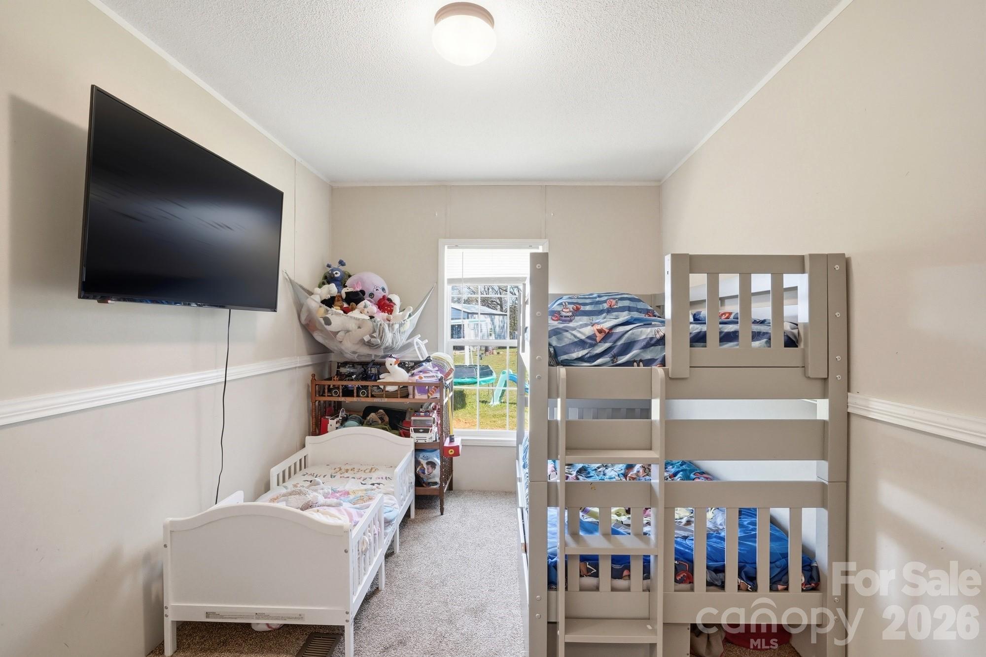 4111 Clontz Taylor Road Marshville, NC 28103 - Photo 18 of 27 a bedroom with furniture and a flat screen tv