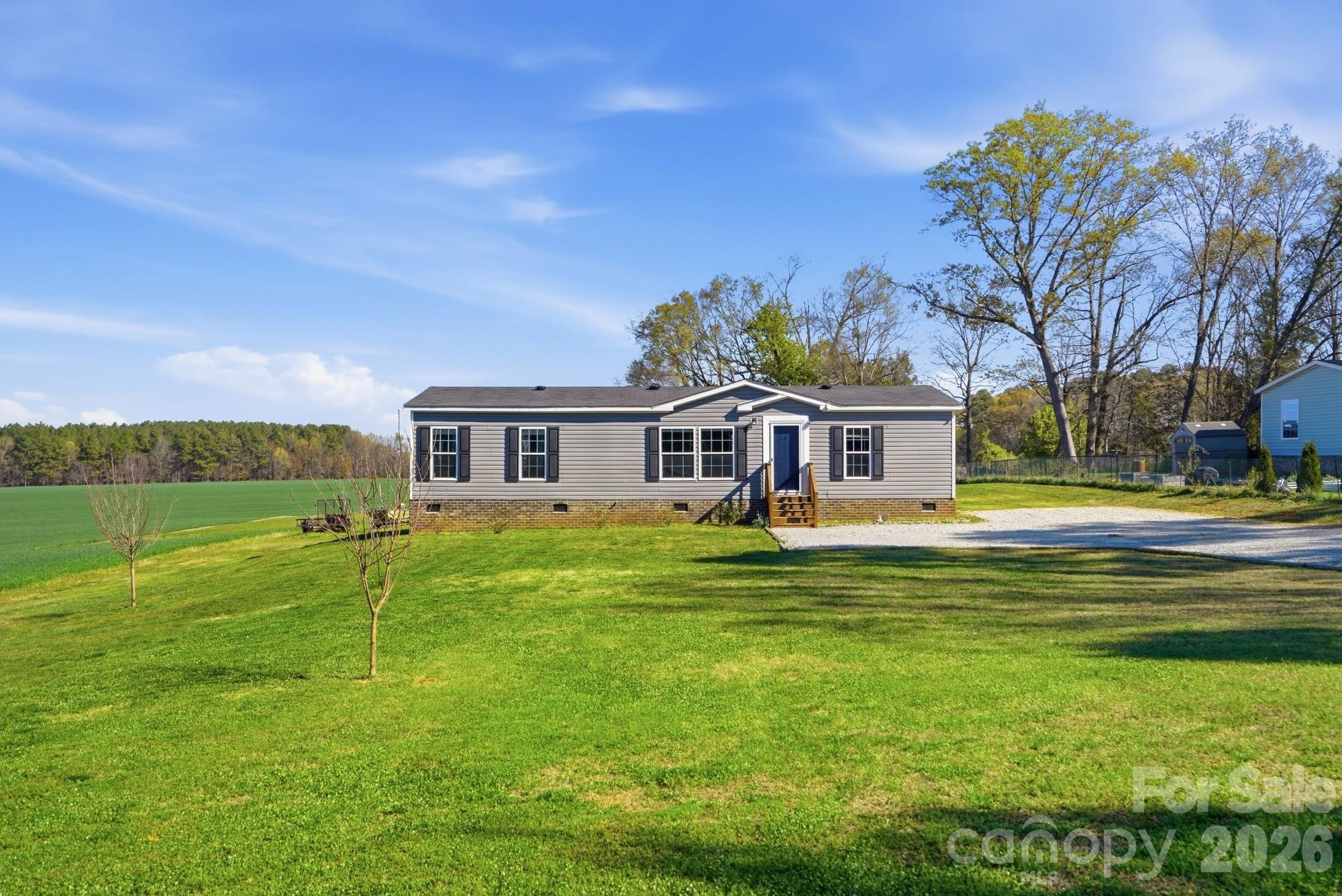 4111 Clontz Taylor Road Marshville, NC 28103 - Photo 2 of 27 a front view of a house with swimming pool having outdoor seating