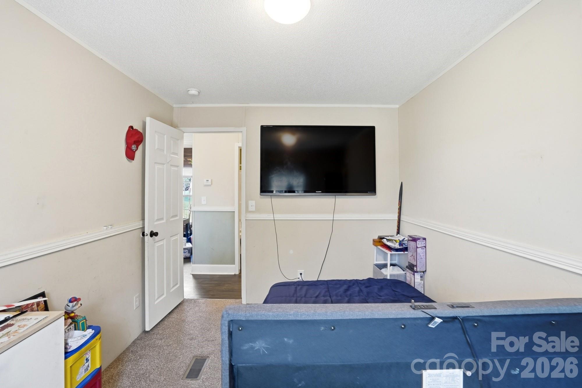 4111 Clontz Taylor Road Marshville, NC 28103 - Photo 21 of 27 a living room with furniture and a flat screen tv