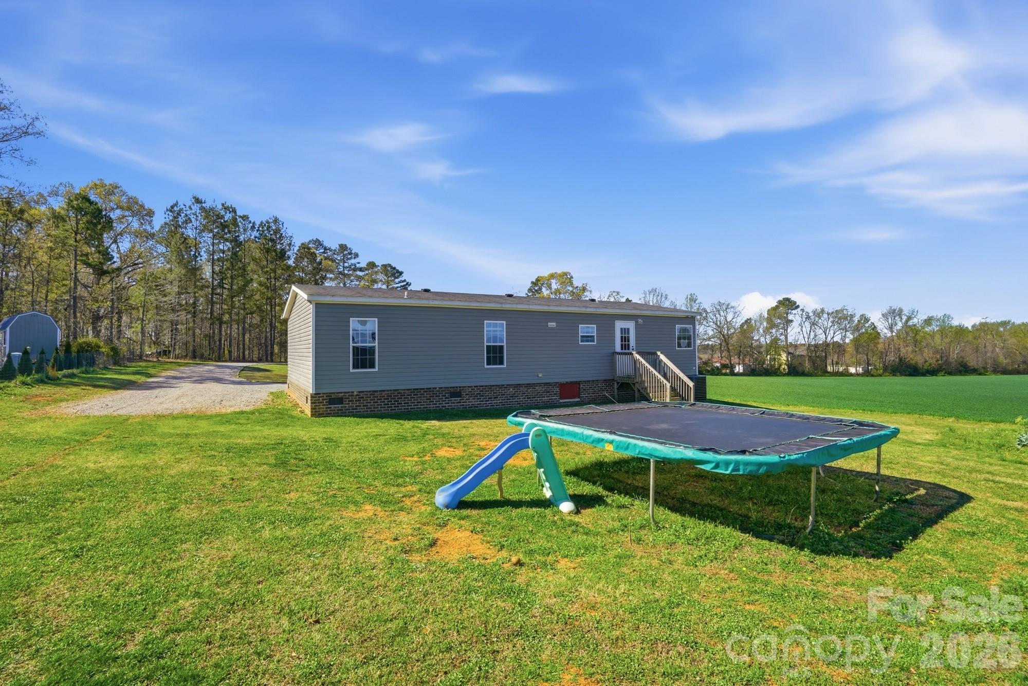 4111 Clontz Taylor Road Marshville, NC 28103 - Photo 22 of 27 a view of a house with pool and a yard
