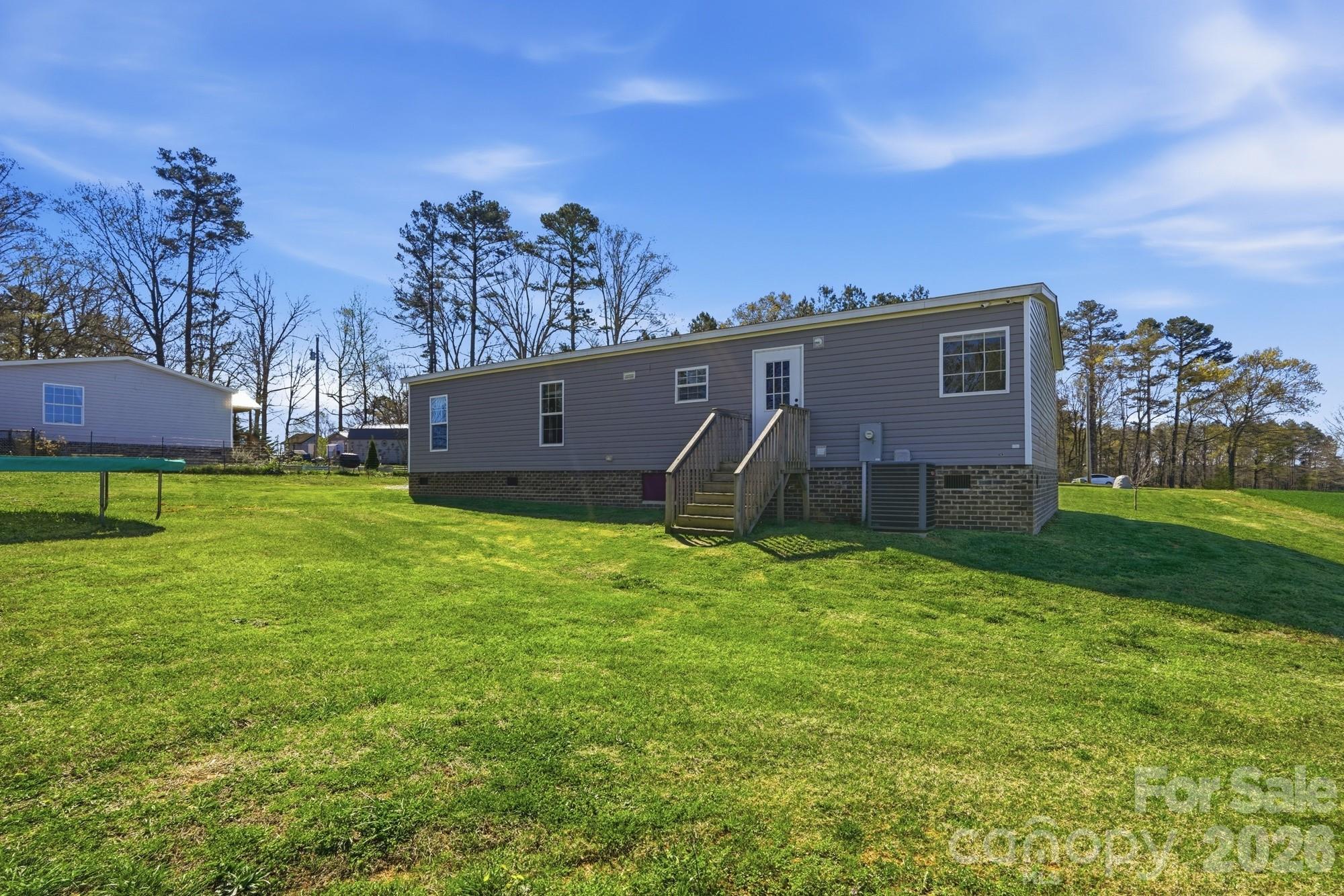 4111 Clontz Taylor Road Marshville, NC 28103 - Photo 26 of 27 a view of a house with a big yard and large trees