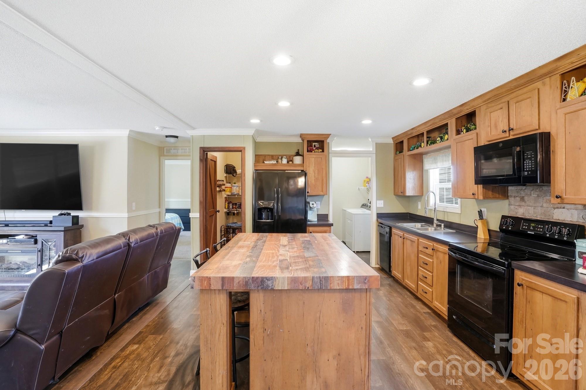 4111 Clontz Taylor Road Marshville, NC 28103 - Photo 7 of 27 a living room with stainless steel appliances furniture and a flat screen tv