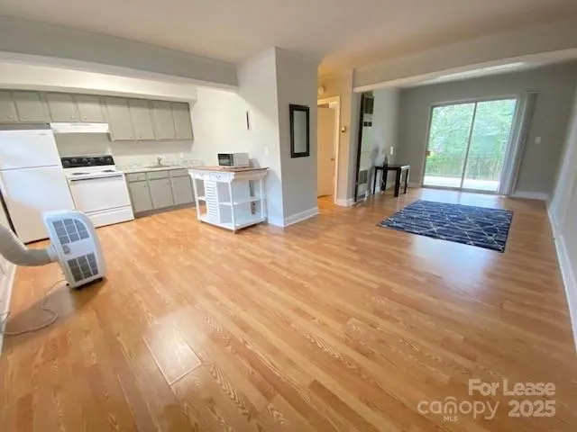 a view of kitchen with furniture and wooden floor