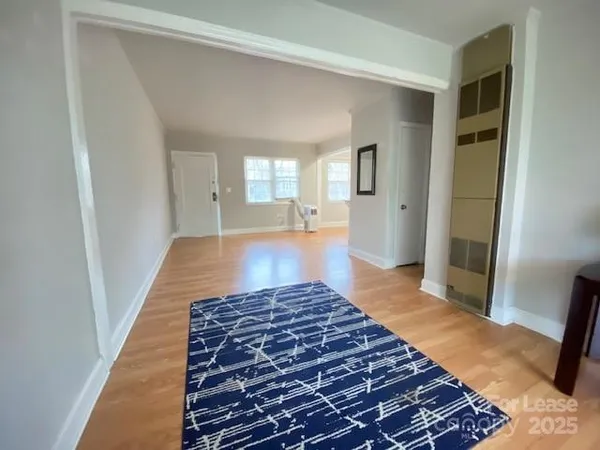 a very nice looking room with wooden floor and a bathroom