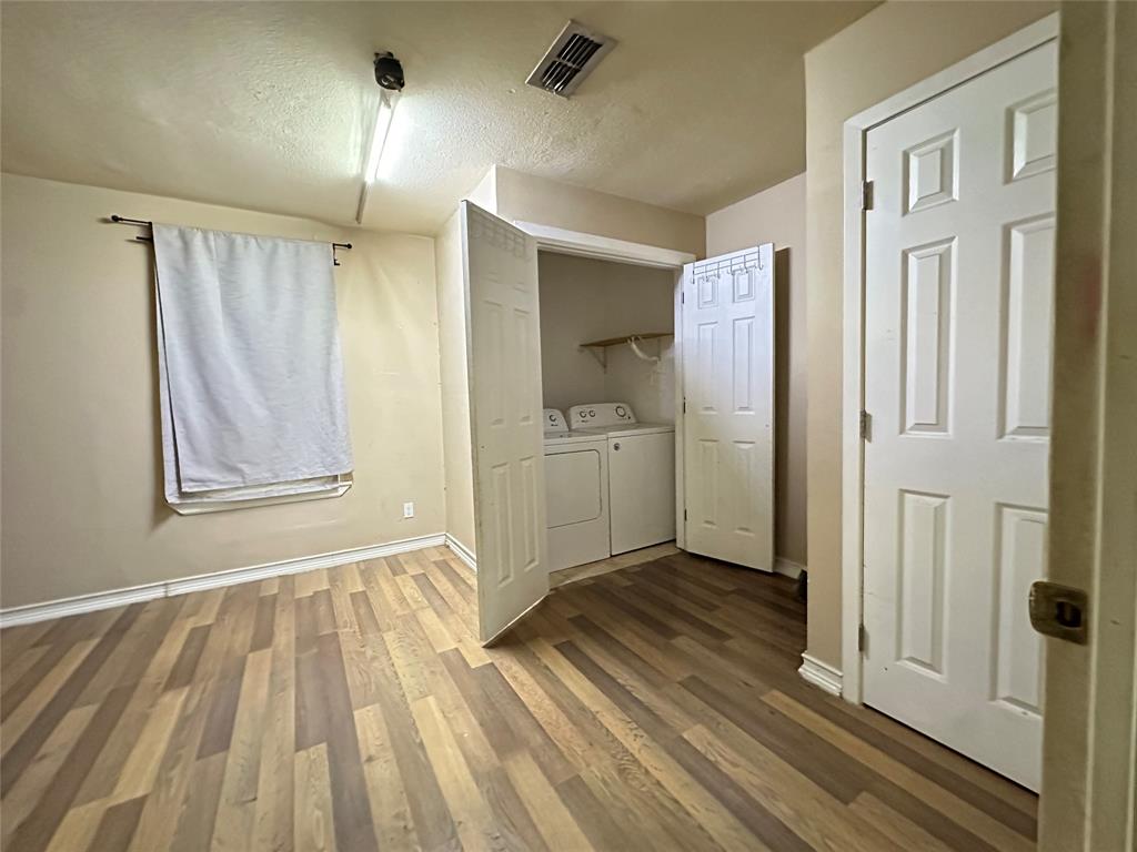 4156 Daniel Lane Lancaster, TX 75134 - Photo 5 of 9 wooden floor in an empty room with a window
