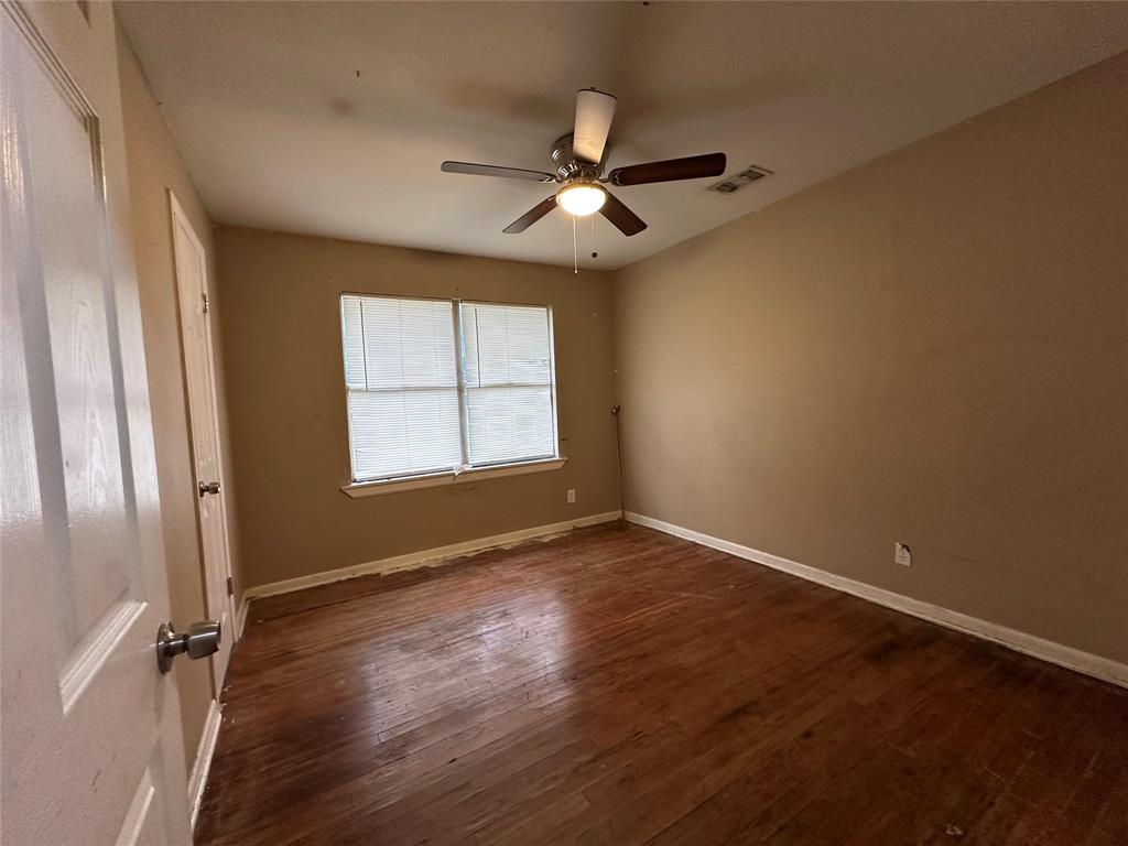 4156 Daniel Lane Lancaster, TX 75134 - Photo 8 of 9 an empty room with wooden floor fan and windows