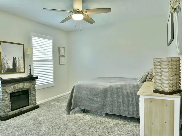 a bedroom with a bed and a fireplace