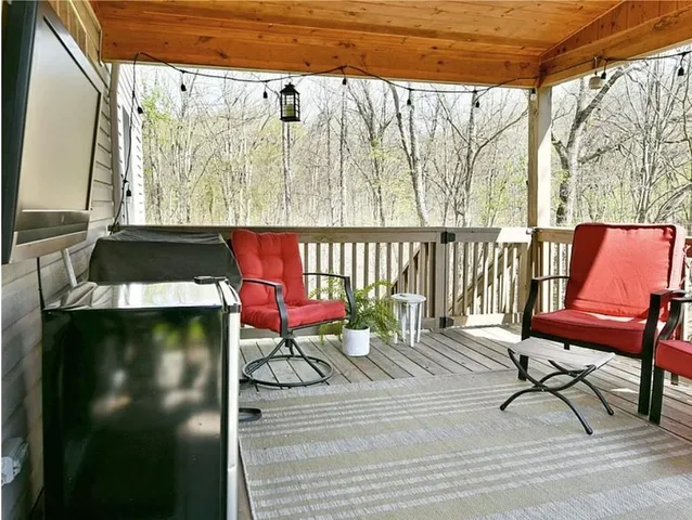 a outdoor view with a sitting space and large trees