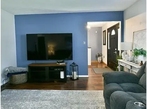 a living room with furniture and a flat screen tv