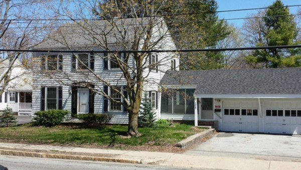 a front view of house with a garden