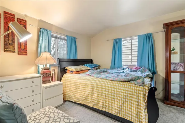 a bedroom with a bed and window