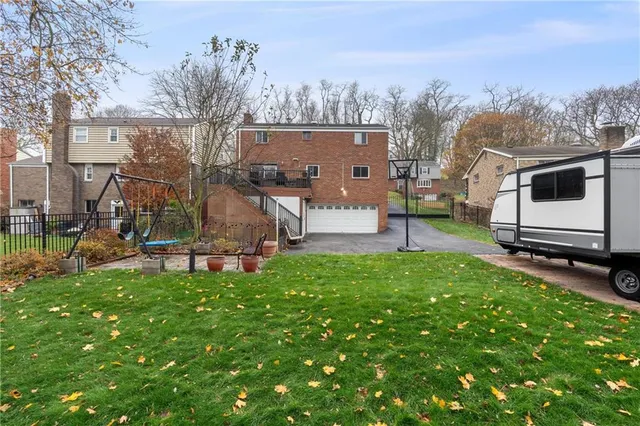 a view of a backyard with a garden and entertaining space
