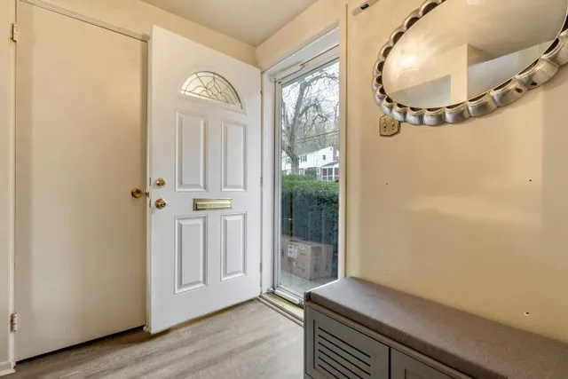 an empty room with wooden floor and mirror