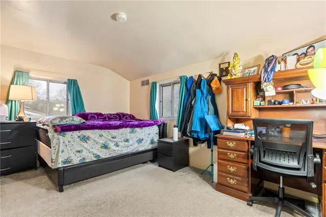 a bed room with a bed and a chair