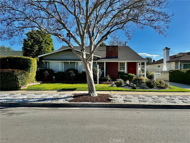 a view of a house with a yard and porch