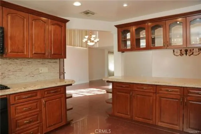 a kitchen with stainless steel appliances granite countertop wooden cabinets a sink and dishwasher