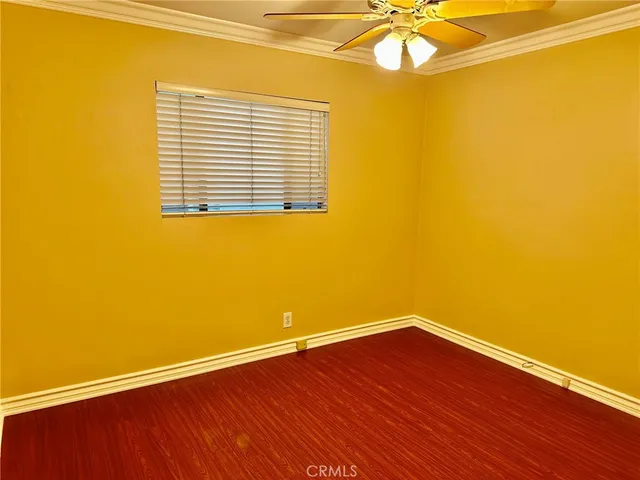 a view of a room with wooden floor and a window