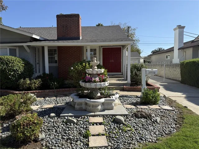 a front view of a house with a yard and outdoor seating