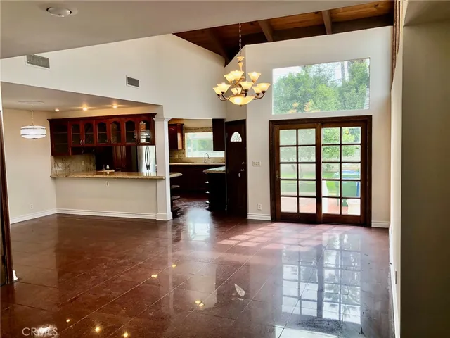 a view of a kitchen with a sink hardwood floor and a large window