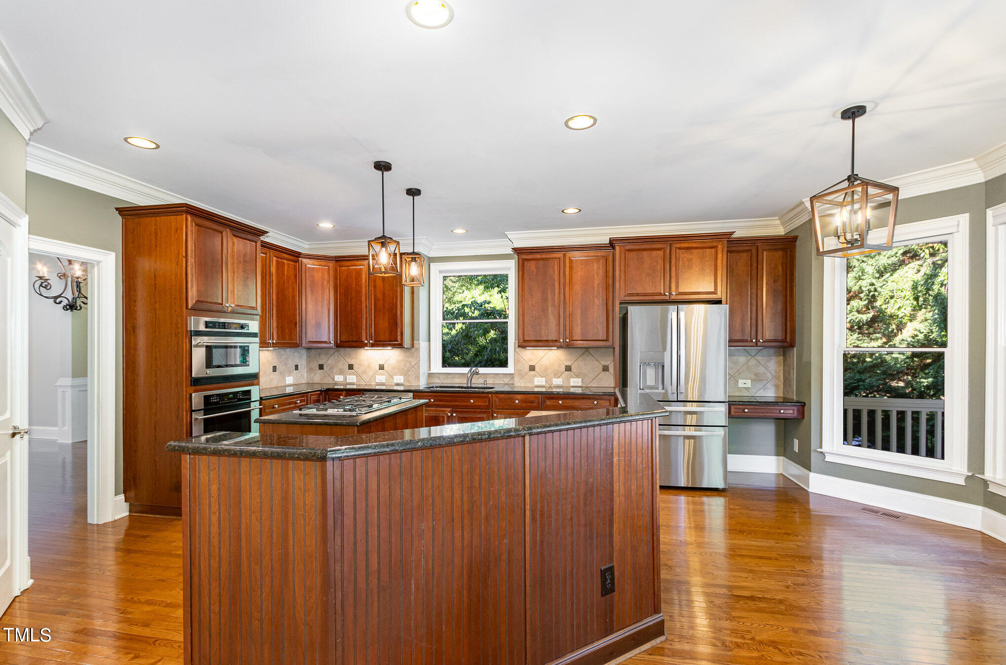 8319 La Matisse Road Raleigh, NC 27615 - Photo 13 of 46 Large Kitchen with center island, stainless steel appliances, tile backsplash , and fantastic Screen Porch attached.