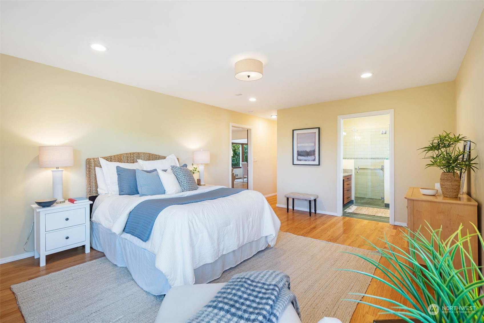 3244 Northwest 59th Street Seattle, WA 98107 - Photo 12 of 40 a bedroom with a large bed and a chandelier