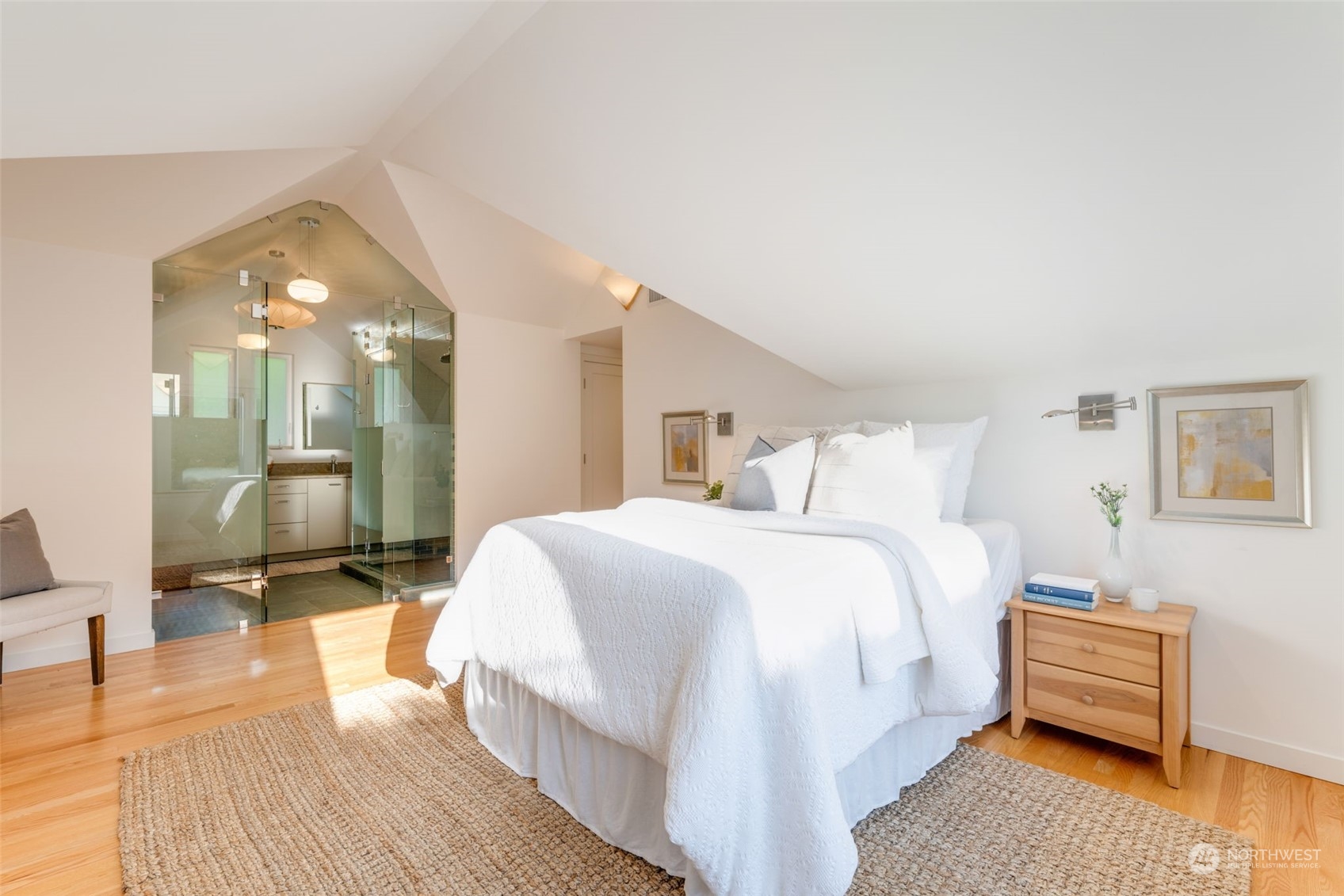 3244 Northwest 59th Street Seattle, WA 98107 - Photo 17 of 40 a spacious bedroom with a bed a table and painting on the wall