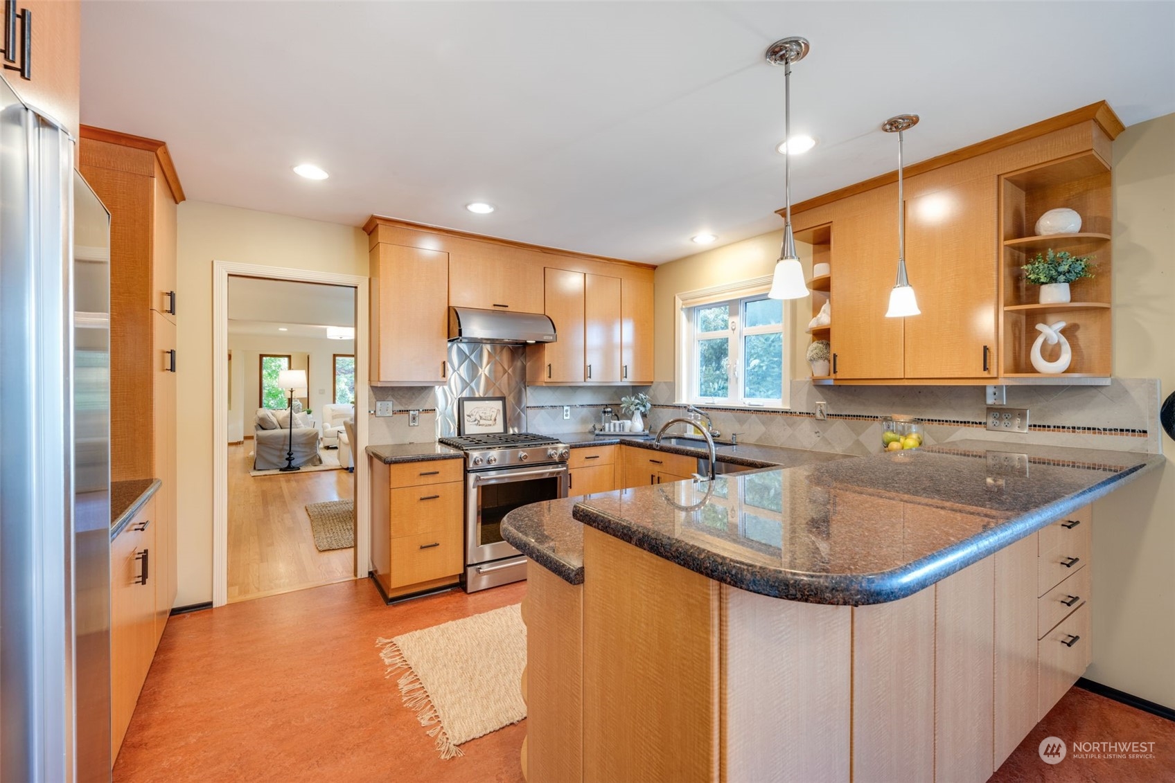 3244 Northwest 59th Street Seattle, WA 98107 - Photo 5 of 40 a kitchen with stainless steel appliances granite countertop a sink a stove and a refrigerator