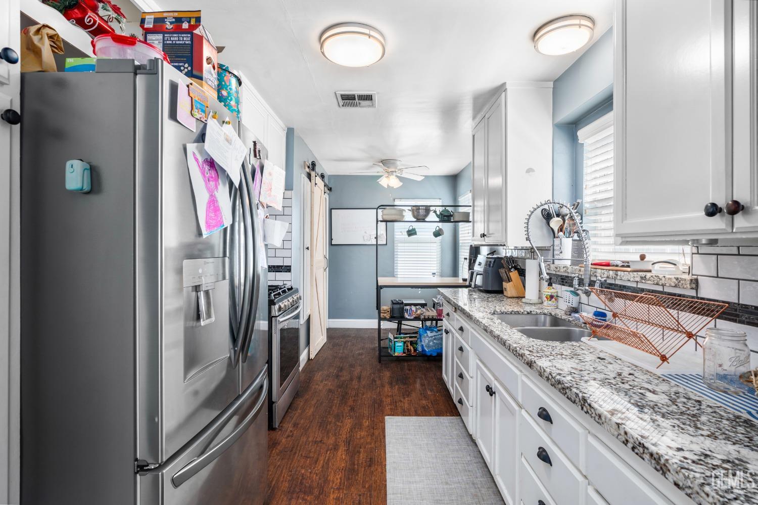 Undisclosed Address Bakersfield, CA 93304 - Photo 11 of 31 a kitchen with stainless steel appliances granite countertop a refrigerator and a sink