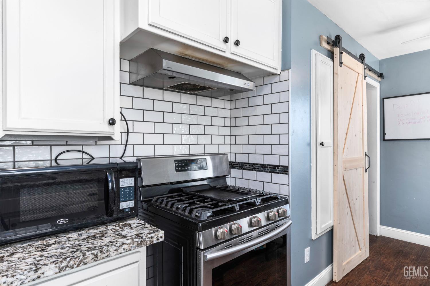 Undisclosed Address Bakersfield, CA 93304 - Photo 13 of 31 a stove top oven sitting inside of a kitchen
