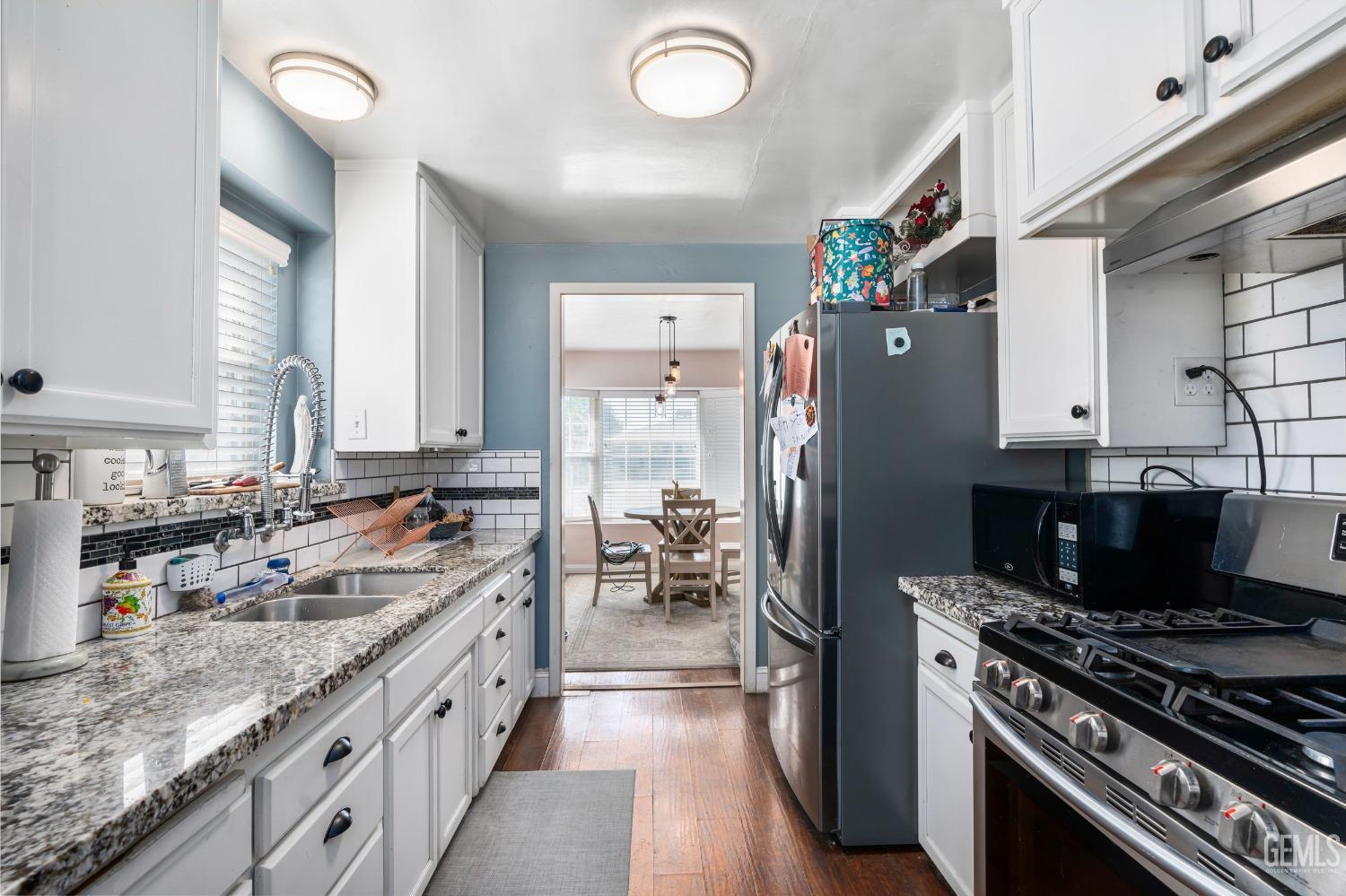 Undisclosed Address Bakersfield, CA 93304 - Photo 15 of 31 a kitchen with refrigerator a stove and a sink