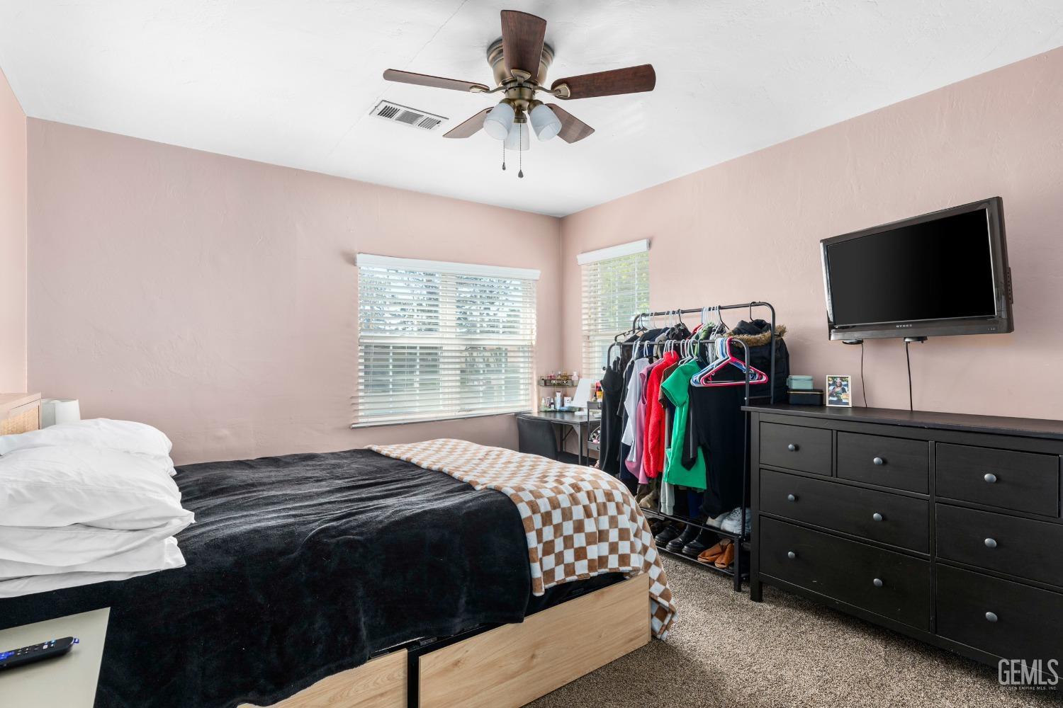 Undisclosed Address Bakersfield, CA 93304 - Photo 16 of 31 a bedroom with a bed and a flat screen tv