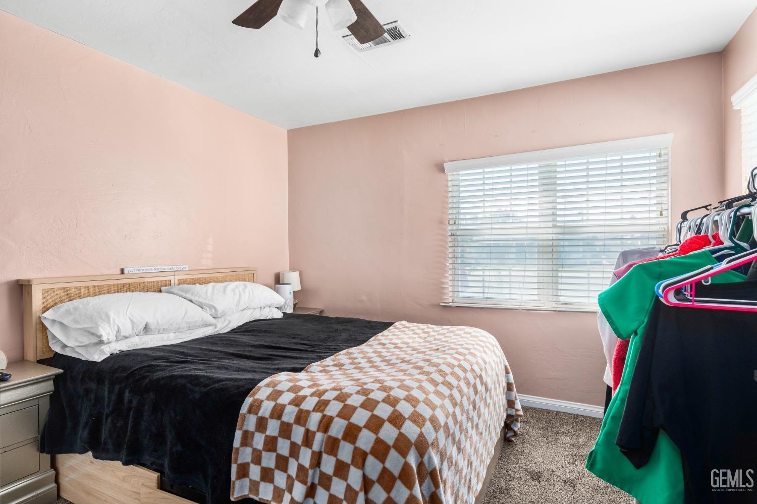 Undisclosed Address Bakersfield, CA 93304 - Photo 17 of 31 a bedroom with a bed and a window