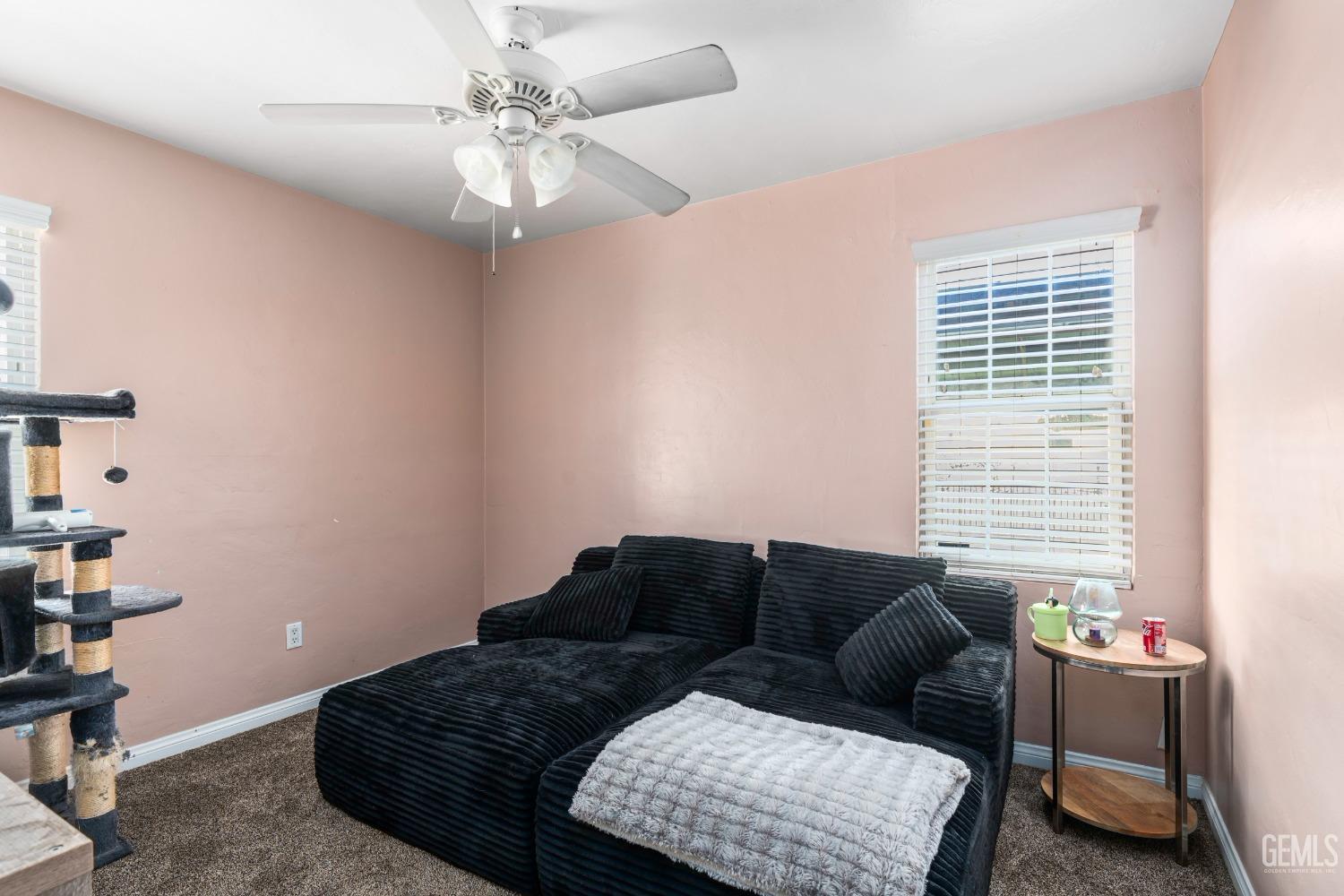 Undisclosed Address Bakersfield, CA 93304 - Photo 20 of 31 a living room with a couch and a chandelier
