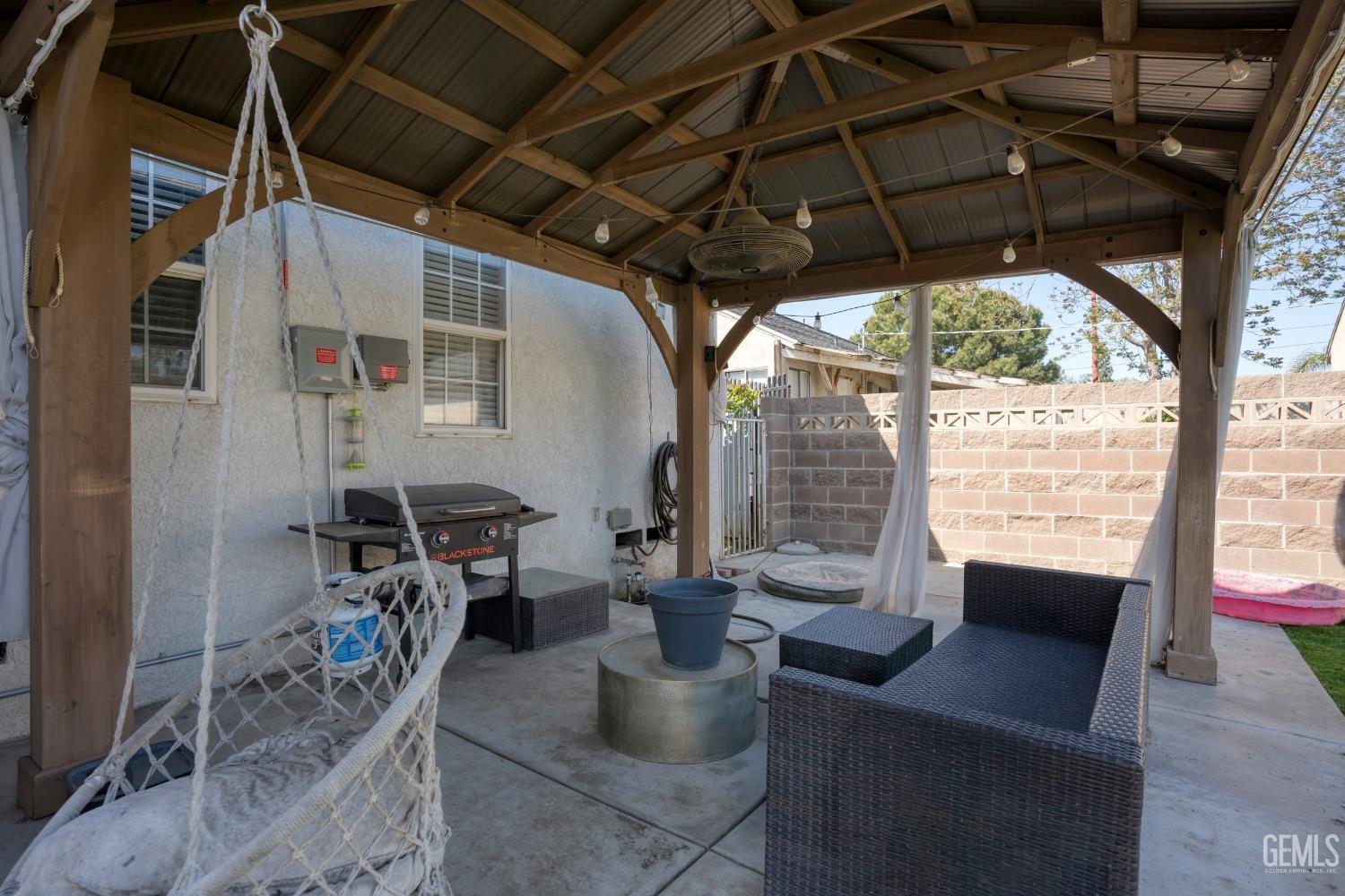 Undisclosed Address Bakersfield, CA 93304 - Photo 24 of 31 a view of a porch with furniture and a yard