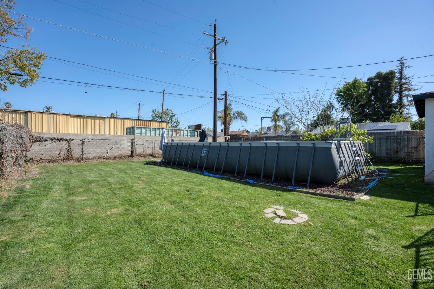 Undisclosed Address Bakersfield, CA 93304 - Photo 28 of 31 a view of a backyard with wooden fence