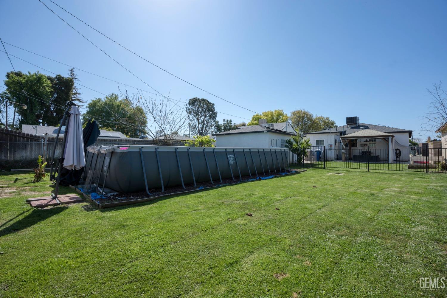 Undisclosed Address Bakersfield, CA 93304 - Photo 29 of 31 a view of a backyard with table and chairs and wooden fence