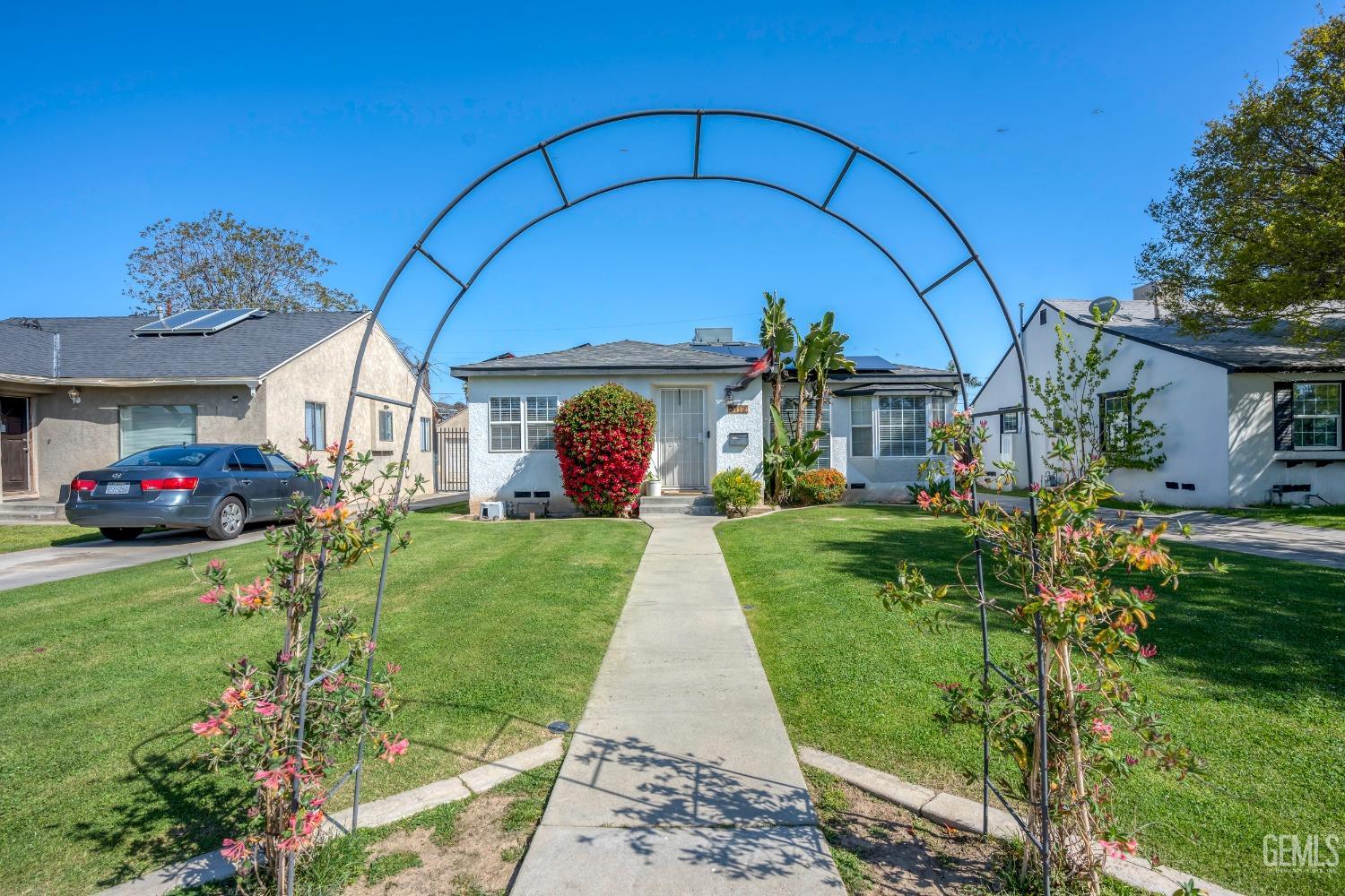 Undisclosed Address Bakersfield, CA 93304 - Photo 4 of 31 a view of a house with a garden and pathway