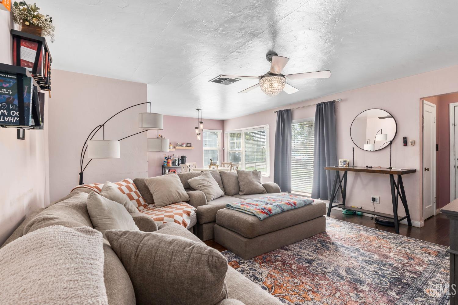 Undisclosed Address Bakersfield, CA 93304 - Photo 7 of 31 a living room with furniture a chandelier and a rug
