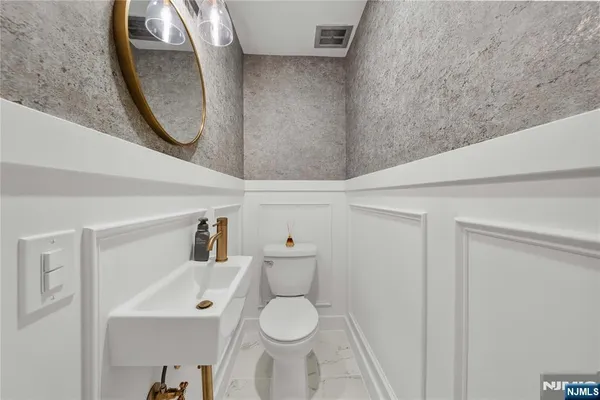 a bathroom with a toilet and a mirror