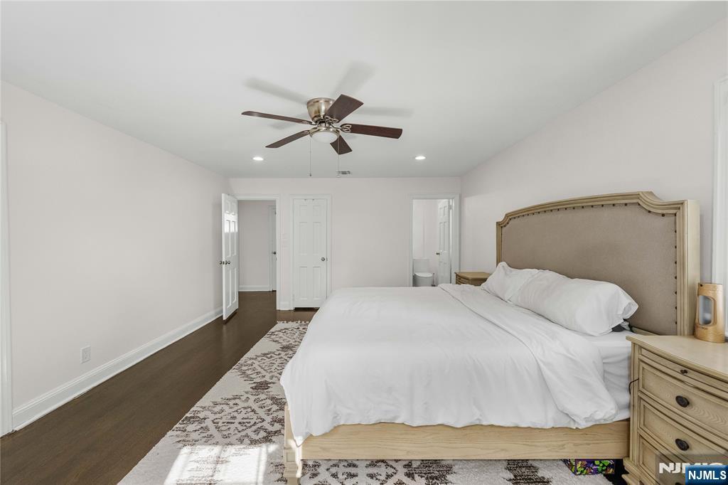 609 Wyndham Road Teaneck, NJ 07666 - Photo 13 of 26 a bedroom with a bed and a chandelier