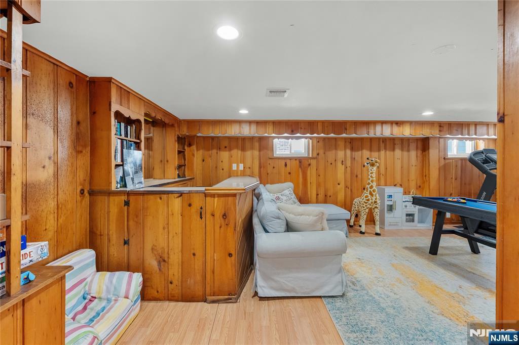 609 Wyndham Road Teaneck, NJ 07666 - Photo 19 of 26 a living room with furniture a wooden floor and next to a window