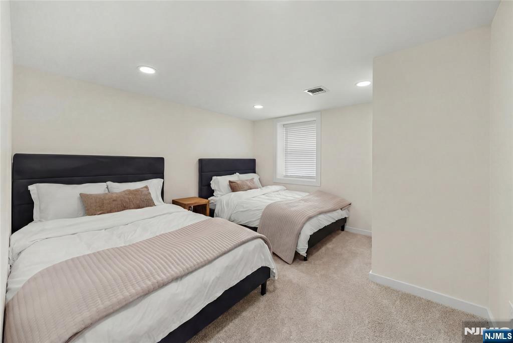 609 Wyndham Road Teaneck, NJ 07666 - Photo 20 of 26 a bedroom with two beds and a lamp