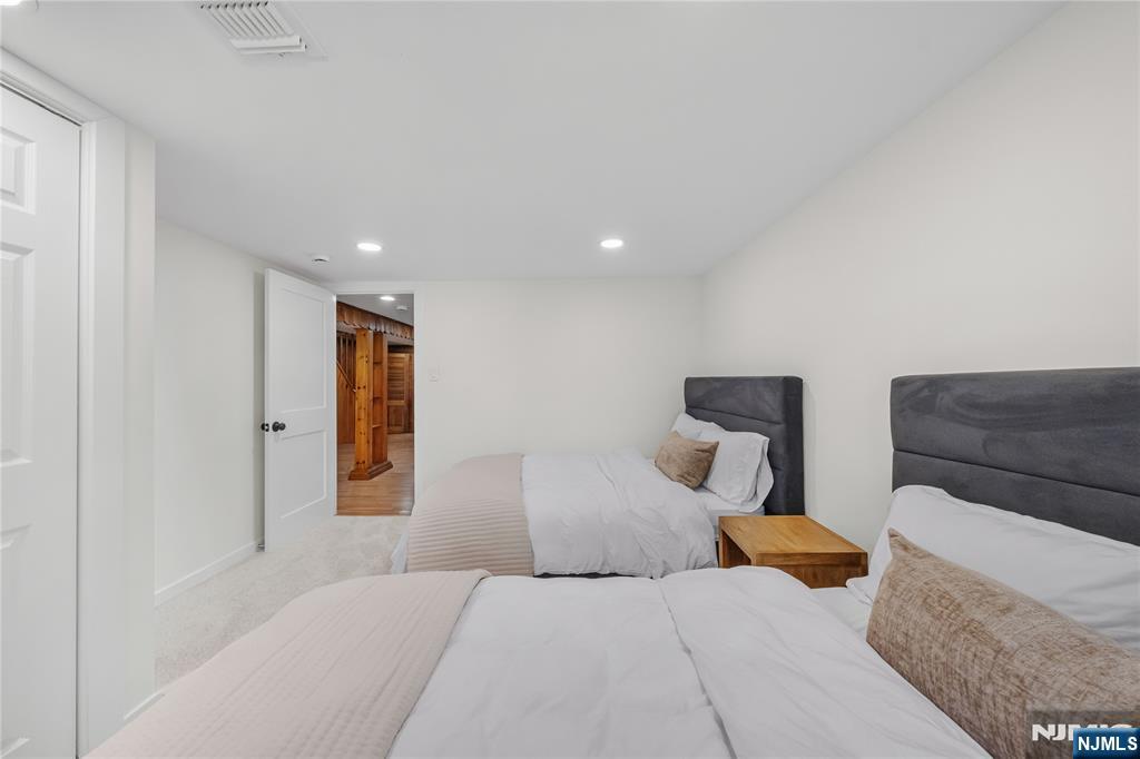 609 Wyndham Road Teaneck, NJ 07666 - Photo 21 of 26 a bedroom with a bed and a couch